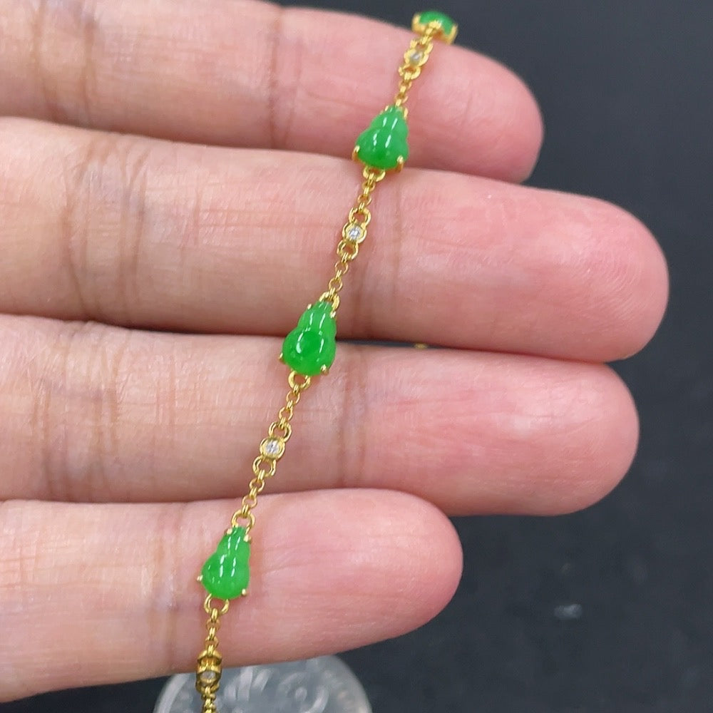 Jadeite gourd bracelet with 18k gold inlay, crafted by HKHQ, featuring a smooth jade surface and intricate gold detailing.
