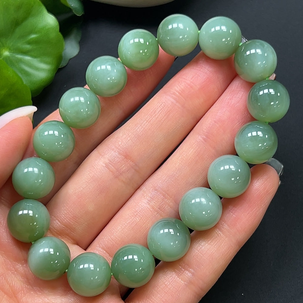 HKHQ Hetian Jade bracelet with 11.8mm beads, showcasing smooth, polished jade stones and a sturdy clasp.
