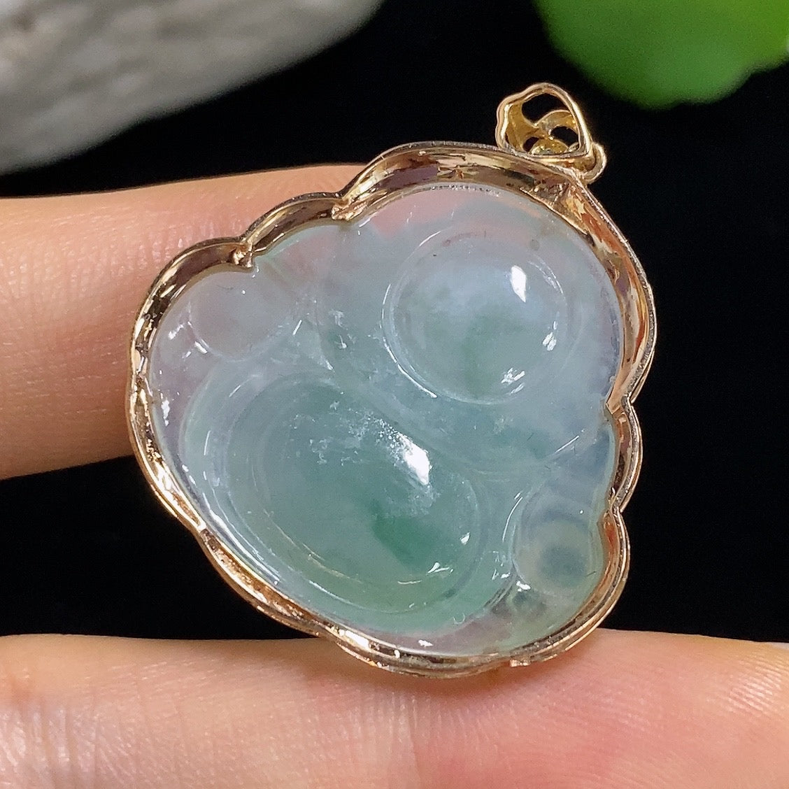 Jadeite Buddha pendant with 18k gold mounting, crafted from green jade, weighing approximately 6.31 grams.