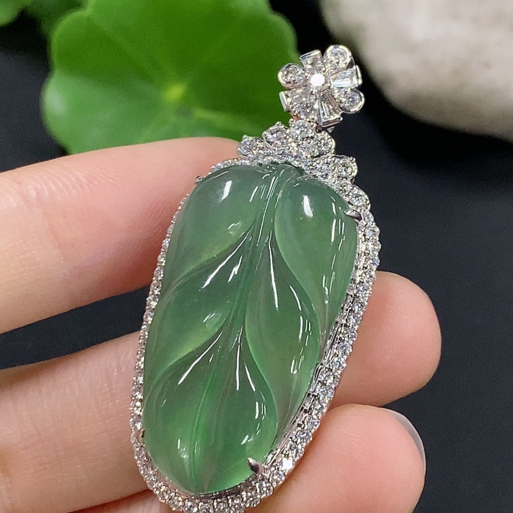 Jadeite leaf pendant with 18K gold and diamond accents, weighing approximately 9.88g, featuring intricate leaf inlay and elegant design.