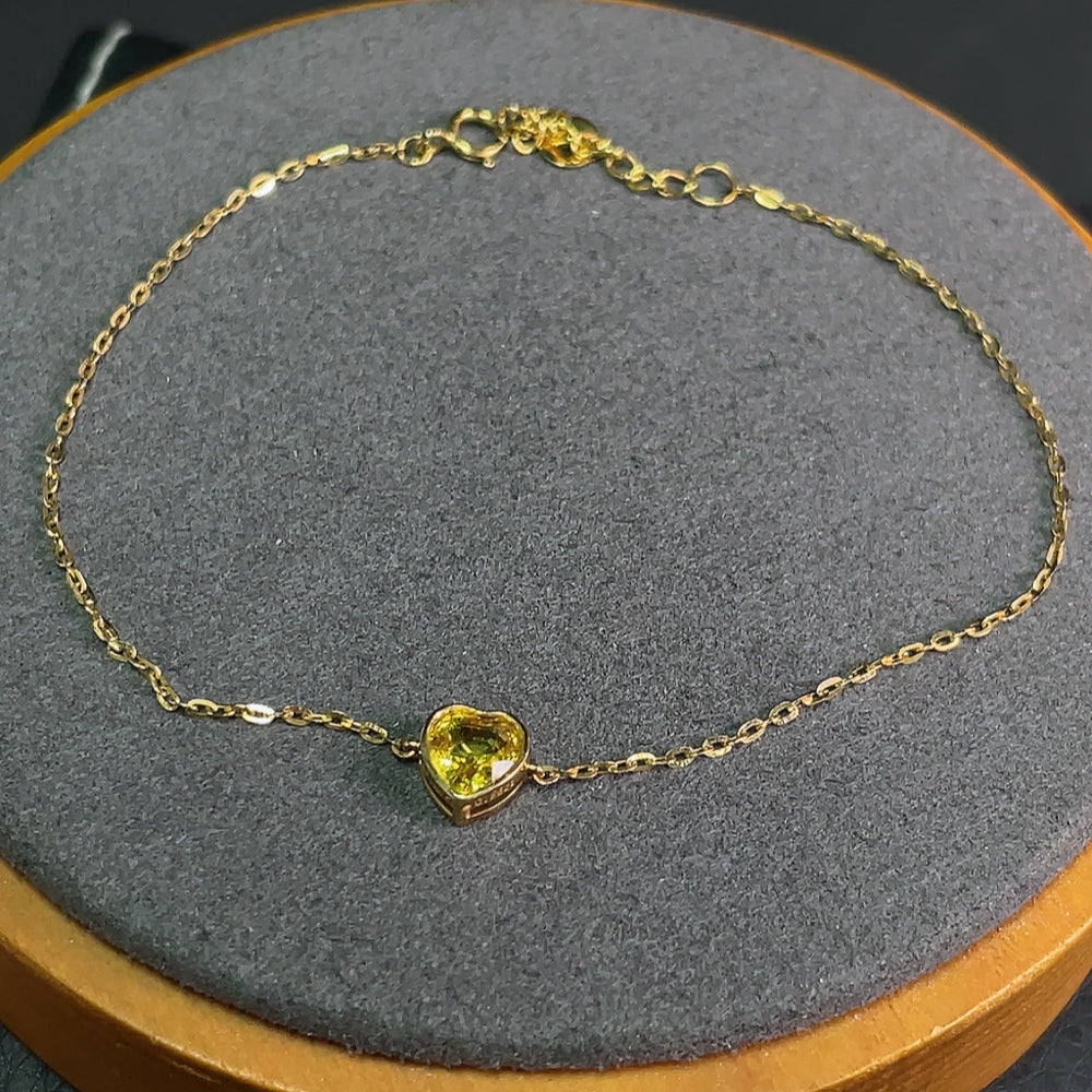 HKHQ sapphire inlaid bracelet with 18k gold, showcasing blue gemstones and elegant design on a delicate jewelry piece.