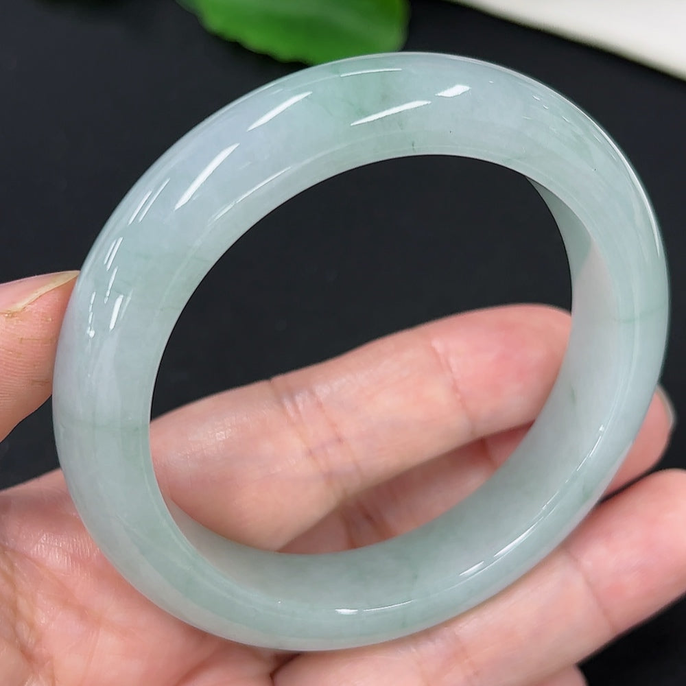 Jadeite round bangle in size 53.7 with approximate weight of 56.5g, featuring a smooth, polished jade surface.