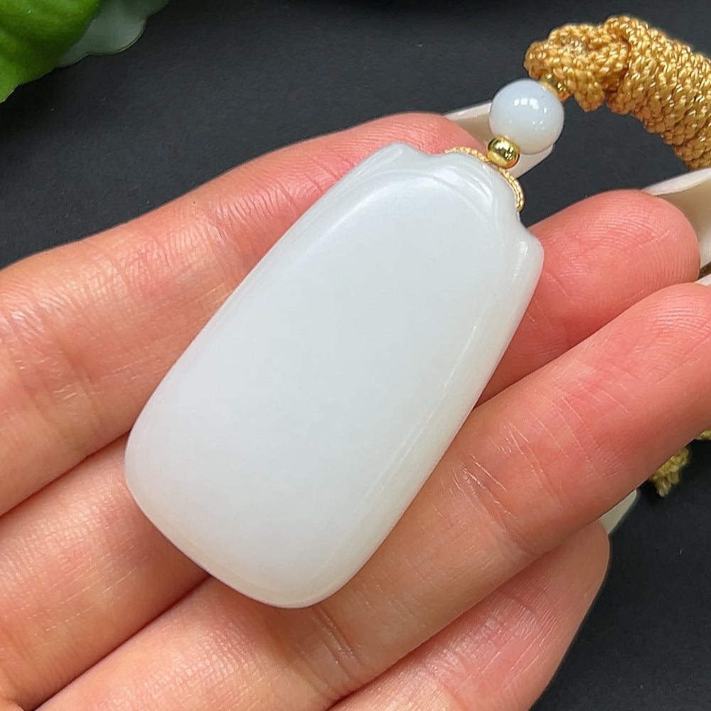HKHQ Hetian Jade plain pendant with rope, weighs approximately 27.31g, showcasing smooth, polished jade craftsmanship.