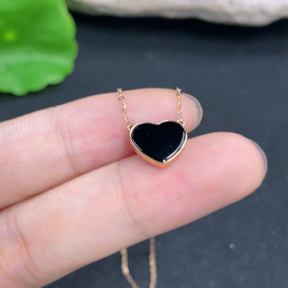 Jadeite heart inlaid pendant with 18k gold chain, weighing approximately 1g, featuring intricate jade craftsmanship.