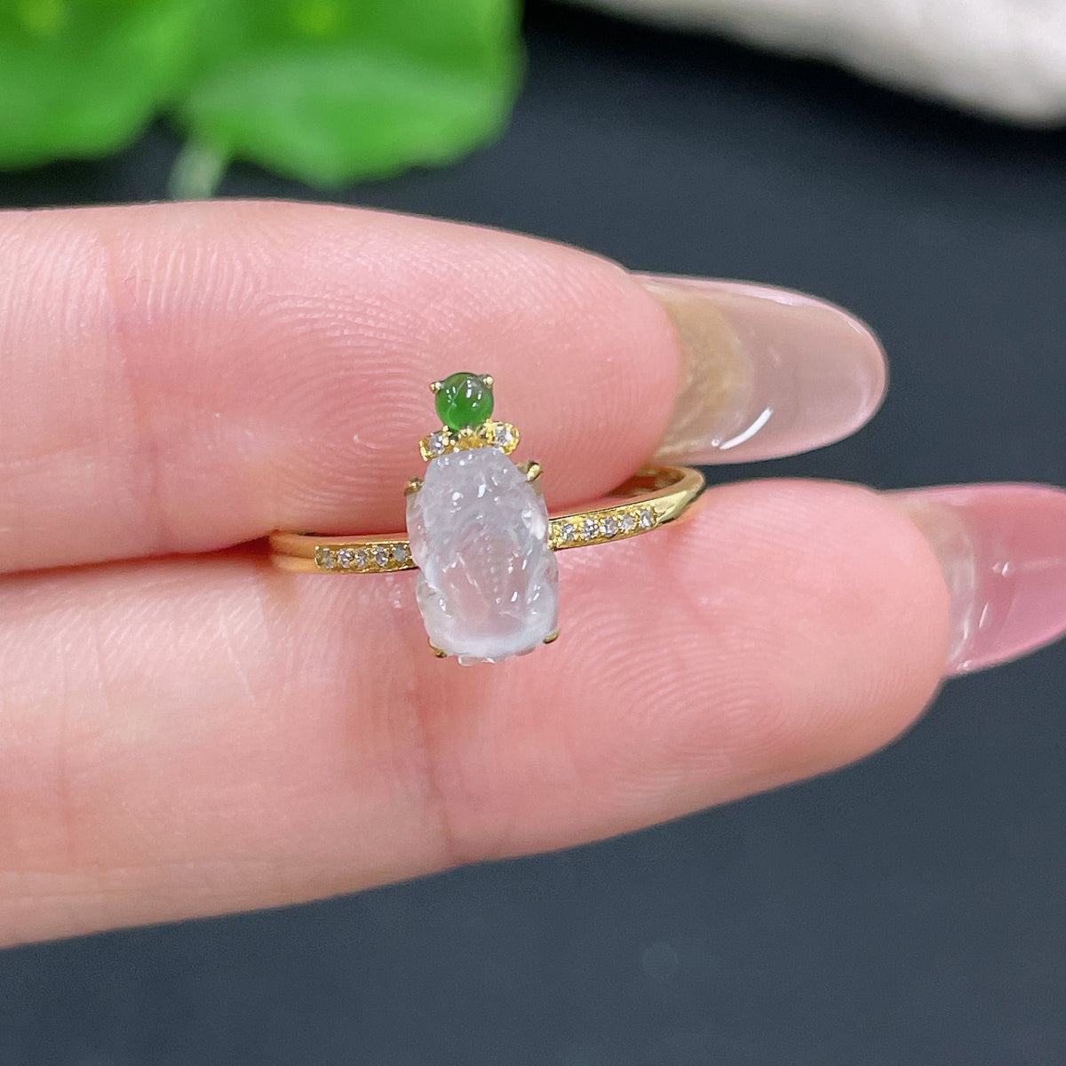 Jadeite ring by HKHQ with 18K gold inlay and diamond accents, showcasing a polished jade gemstone on a delicate gold band.