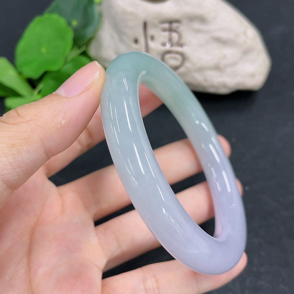 HKHQ jadeite round bangle, size 57.1 with 70.28g, showcasing smooth, polished green jadeite bracelet on a neutral background.