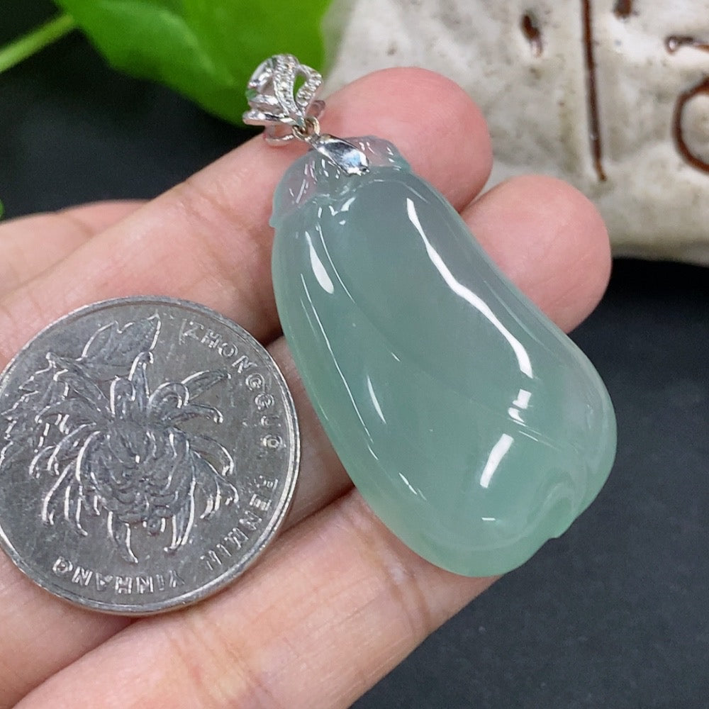 Jadeite pendant featuring a blessing melon design with 18K gold and diamond accents, displayed on a necklace.