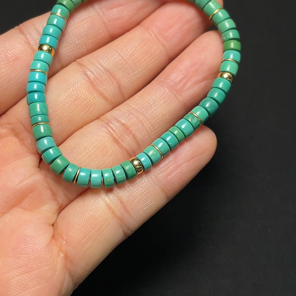 18K gold turquoise bracelet with 4.7mm beads, weighing approximately 7.02g, featuring vibrant turquoise stones and gold accents.