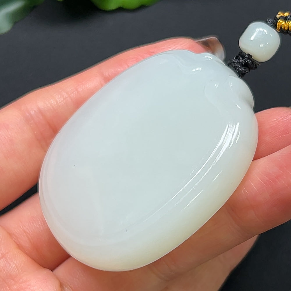 Hetian jade plain pendant with rope, weighing approximately 64.08g, showcasing smooth, polished jade craftsmanship by HKHQ.