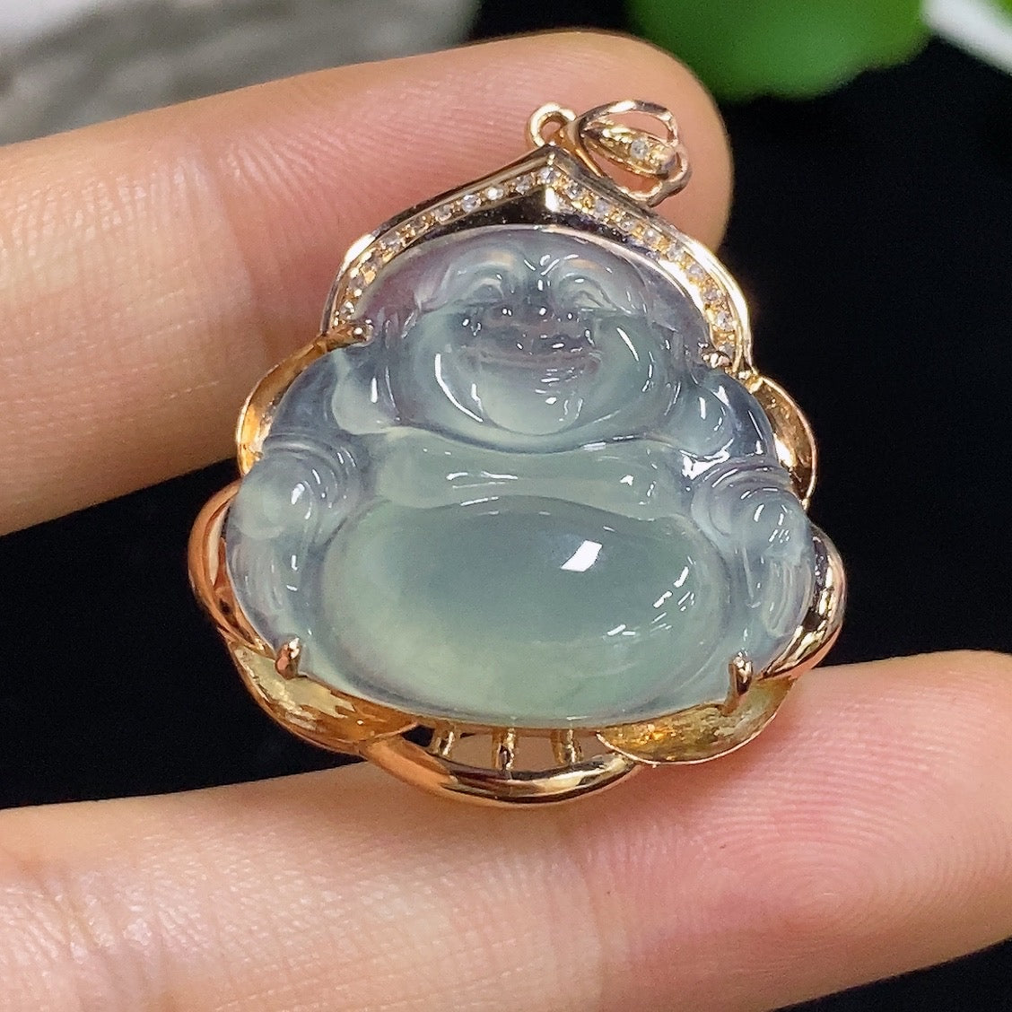 Jadeite Buddha pendant by HKHQ with 18k gold accents and diamond details, showcasing intricate craftsmanship and spiritual symbolism.