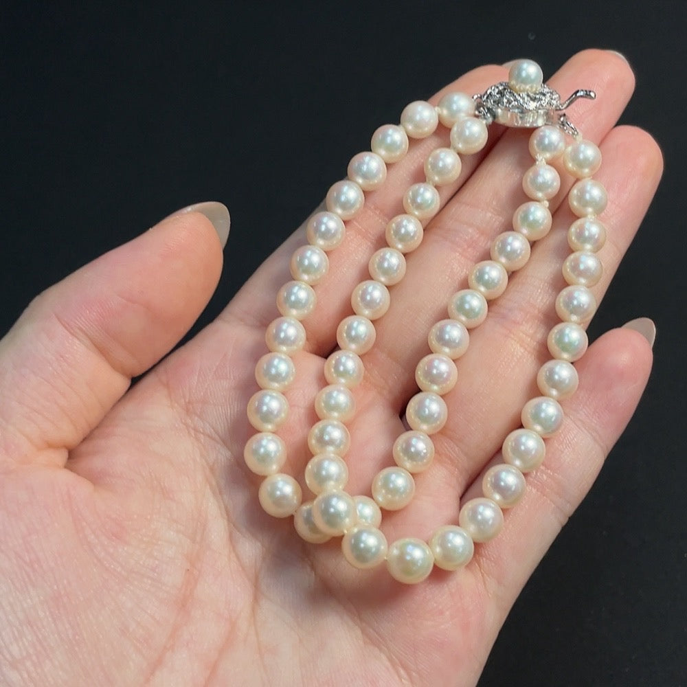 HKHQ seawater pearl strand with 6.4mm pearls, total weight 21.19g, showcasing lustrous non-gold pearls arranged in a strand.