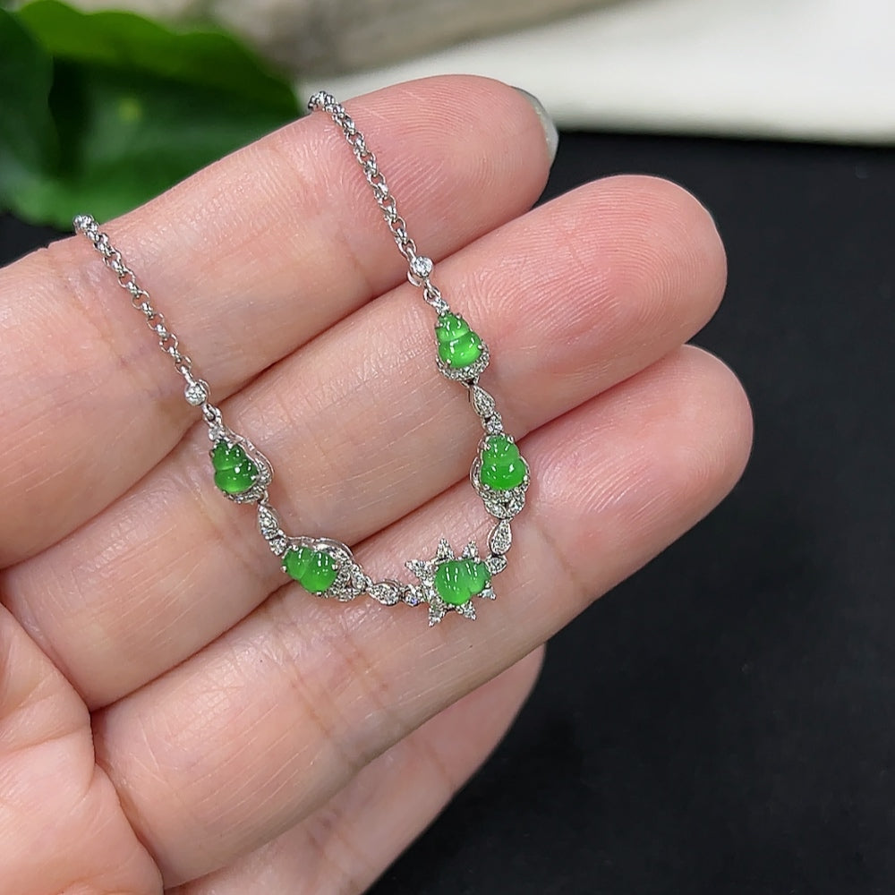 Jadeite gourd inlaid bracelet by HKHQ featuring 18k gold and diamond accents, showcasing intricate craftsmanship and smooth jade surface.