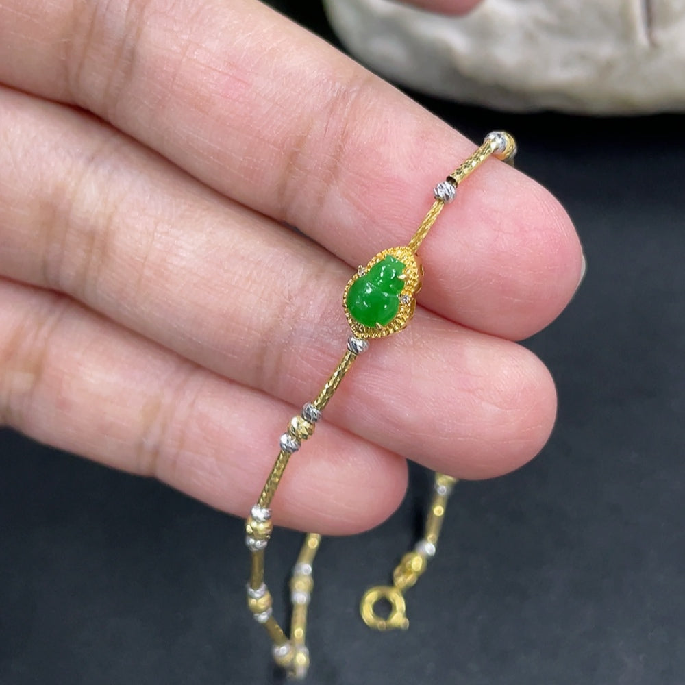 Jadeite gourd bracelet with 18k gold inlay and diamond accents, featuring intricate design on a delicate jewelry piece.