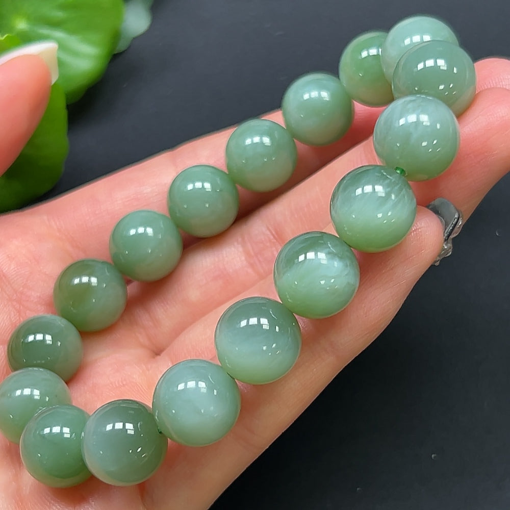 HKHQ Hetian Jade bracelet with 11.8mm beads, showcasing smooth, polished green jade stones on a delicate bracelet.