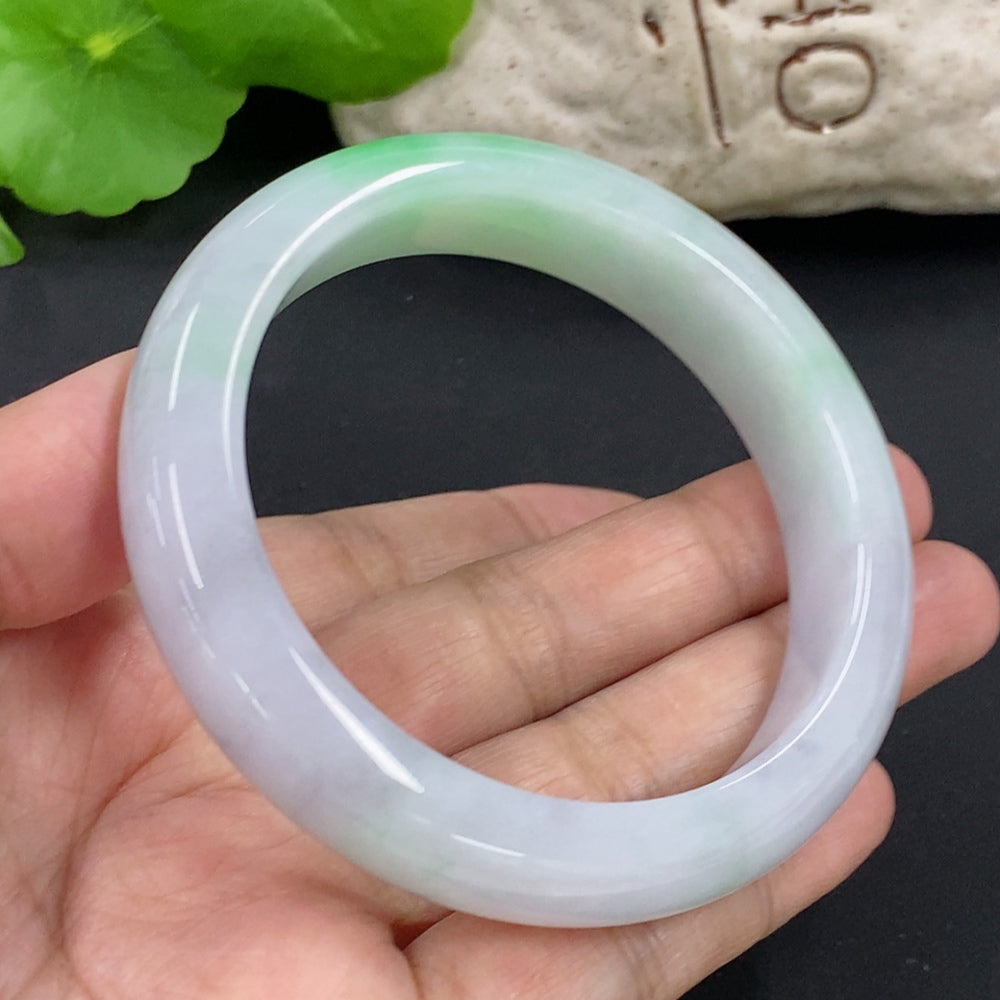 HKHQ jadeite round bangle, size 57.1, weighs 64.6g, showcasing smooth, polished green jadeite bracelet on a neutral background.