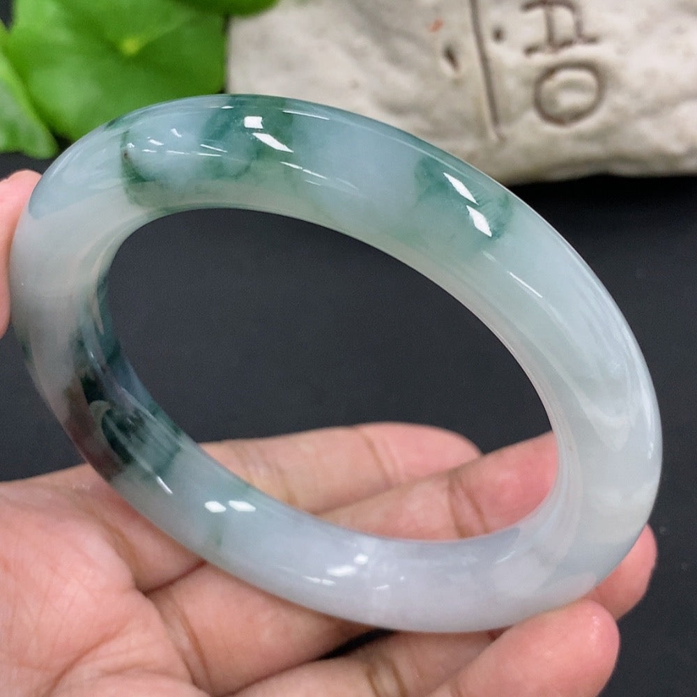 HKHQ jadeite round bangle, size 54.9, with mineral components, showcasing smooth, polished jade jewelry design.