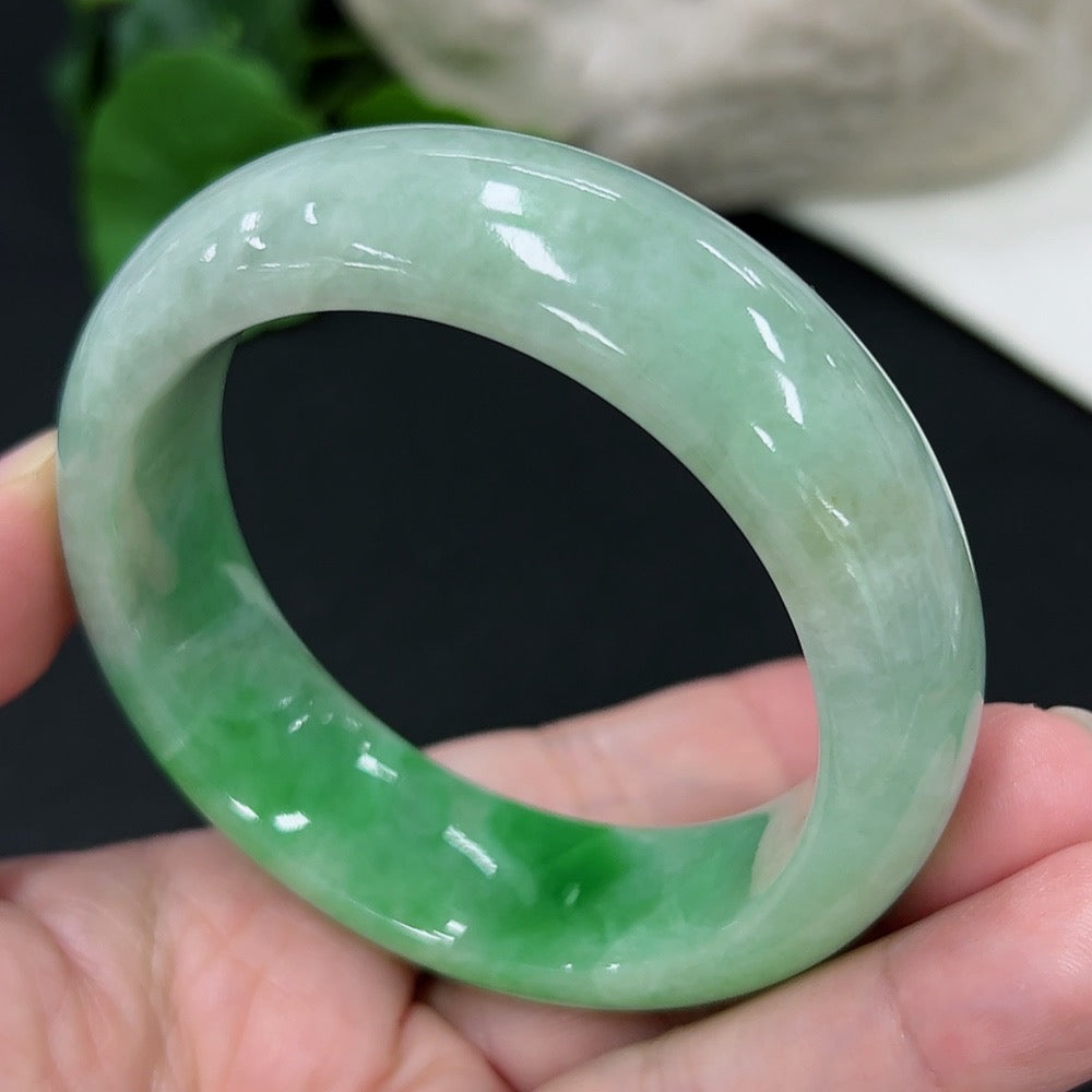Jadeite round bangle from HKHQ, size 53.6, showcasing smooth, polished jade surface and elegant circular design.