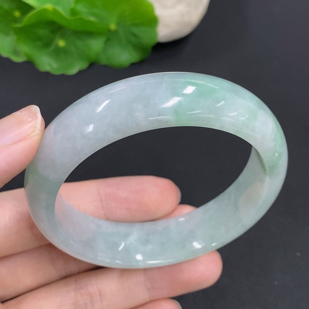 HKHQ jadeite round bangle, 64.6g weight, size 54.5, smooth polished jade jewelry on a white background.