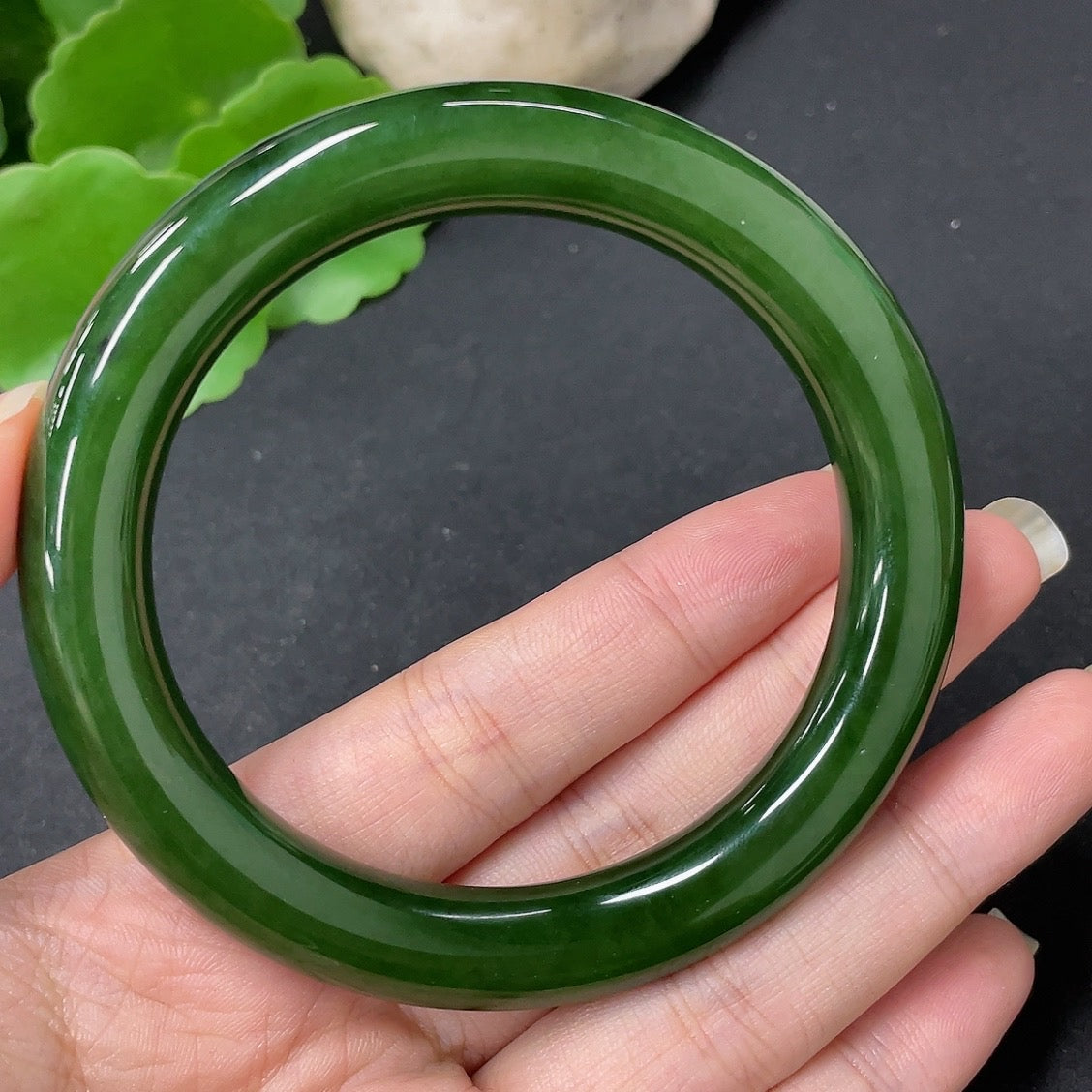Green Hetian Jade round bangle, size 58.7, crafted by HKHQ, with an approximate weight of 56.9g, showcasing smooth polished surface.