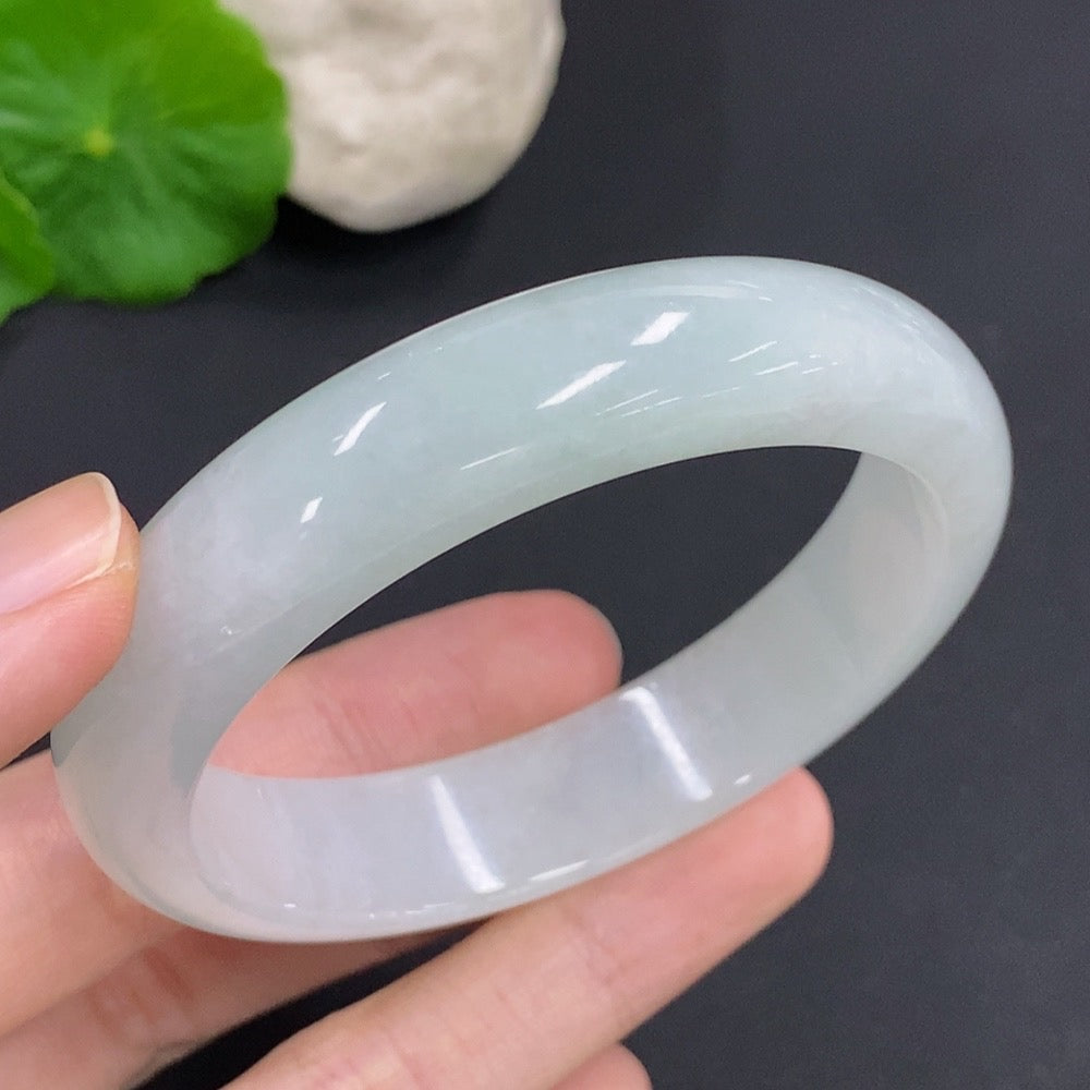 Jadeite round bangle with a total weight of 52.7g and size 55.7, showcasing smooth, polished jadeite surface and craftsmanship.