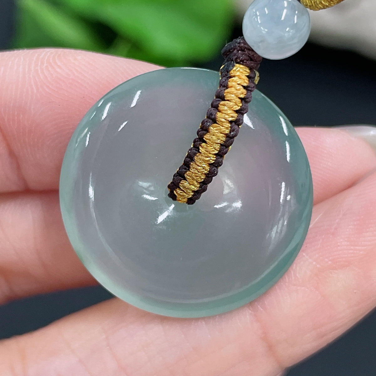 Jadeite pendant with peace knot design, weighing approximately 6.68g, featuring smooth green jade stone on a simple jewelry setting.
