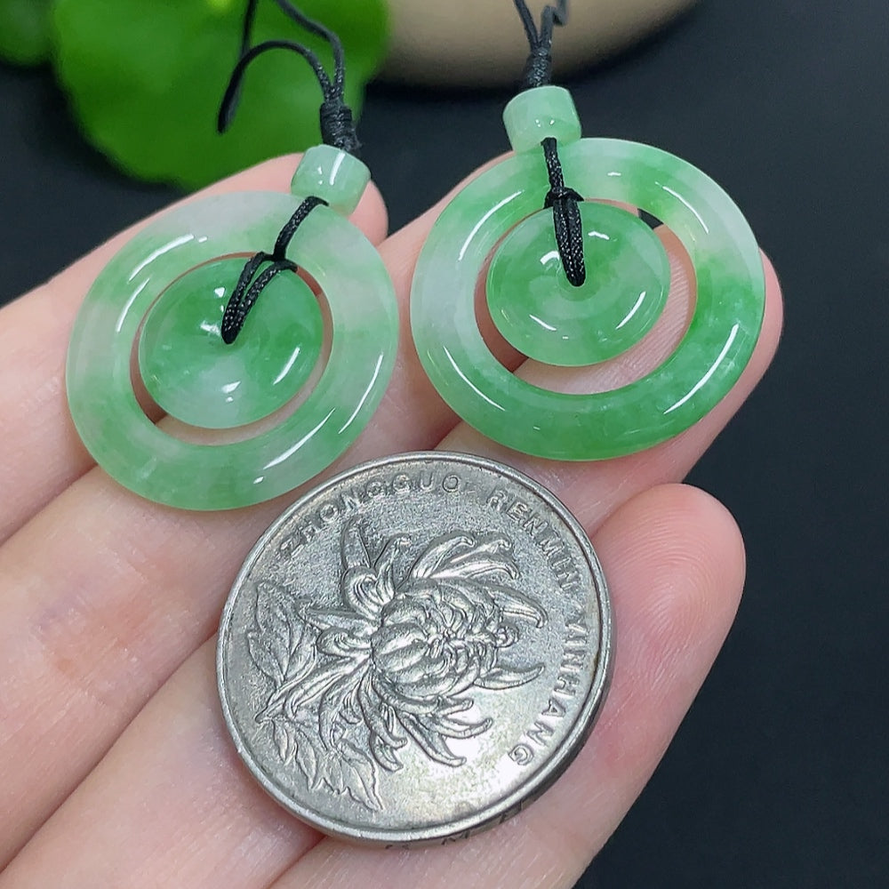 Jadeite pendant with mother-and-child buckle design from HKHQ, includes cord, weighs approximately 6.11g.