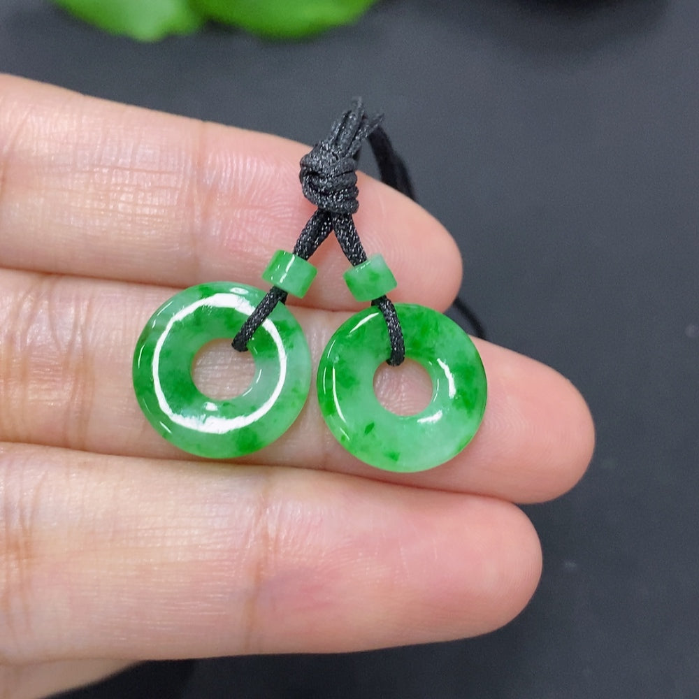 Two jadeite donut pendants for necklaces, totaling approximately 2.3g, displayed on a neutral background.