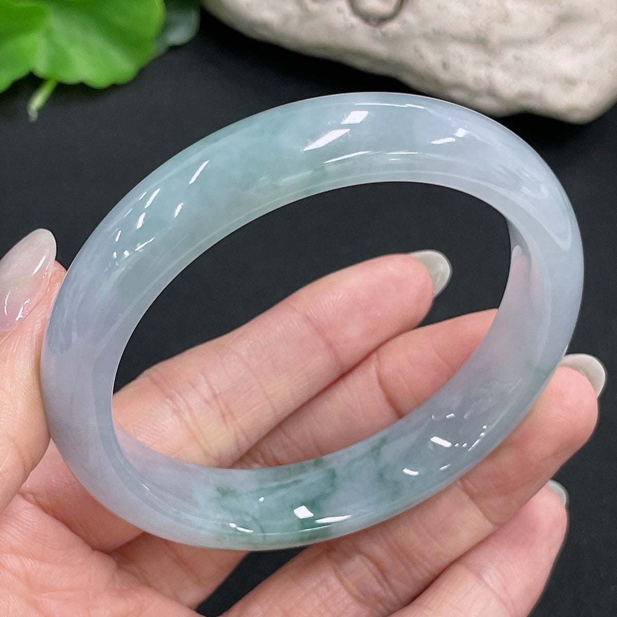 HKHQ jadeite round bangle with 54.6g weight and size 56.3, showcasing smooth, polished jade jewelry on a neutral background.