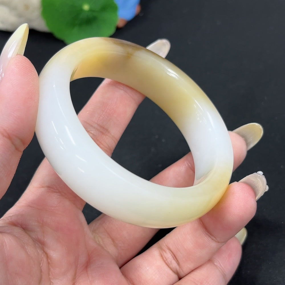 Hetian Jade round bracelet by HKHQ, size 56.8, weighing 74.5g, featuring smooth jade beads with undetermined skin color origin.