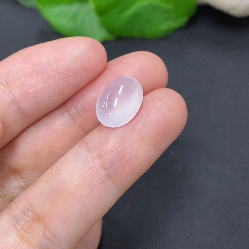 Green jadeite cabochon jewelry piece from HKHQ, showcasing a smooth, polished 1g jadeite gemstone with natural color variations.