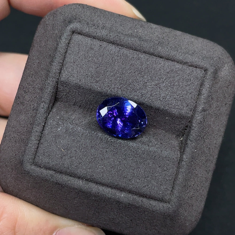 Loose tanzanite gemstone with approximately 4.82 carats, showcasing vibrant blue-purple color and clarity.
