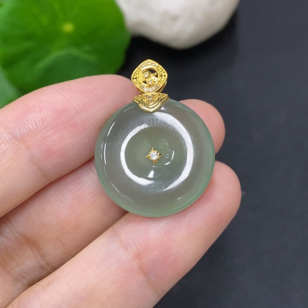 Jadeite Peace Knot jewelry piece with 18k gold clasp, showcasing smooth jade surface and elegant design.