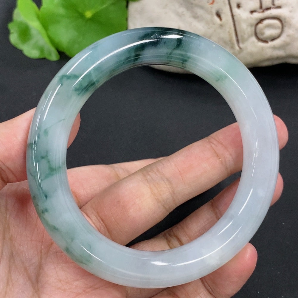 HKHQ jadeite round bangle with mineral components, size 54.9, weighing approximately 65.2g, showcasing smooth, polished jade surface.
