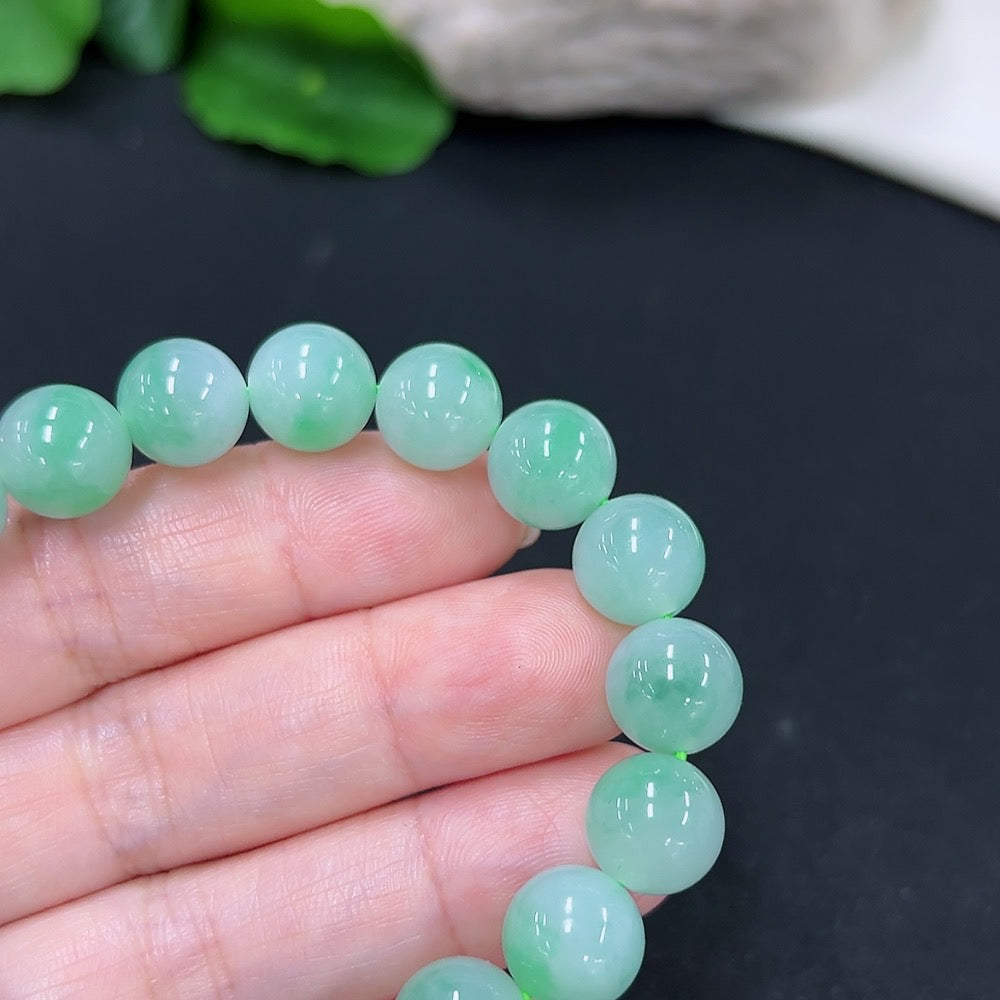 Handcrafted jadeite bracelet from HKHQ featuring smooth, polished green jade beads on a delicate string.