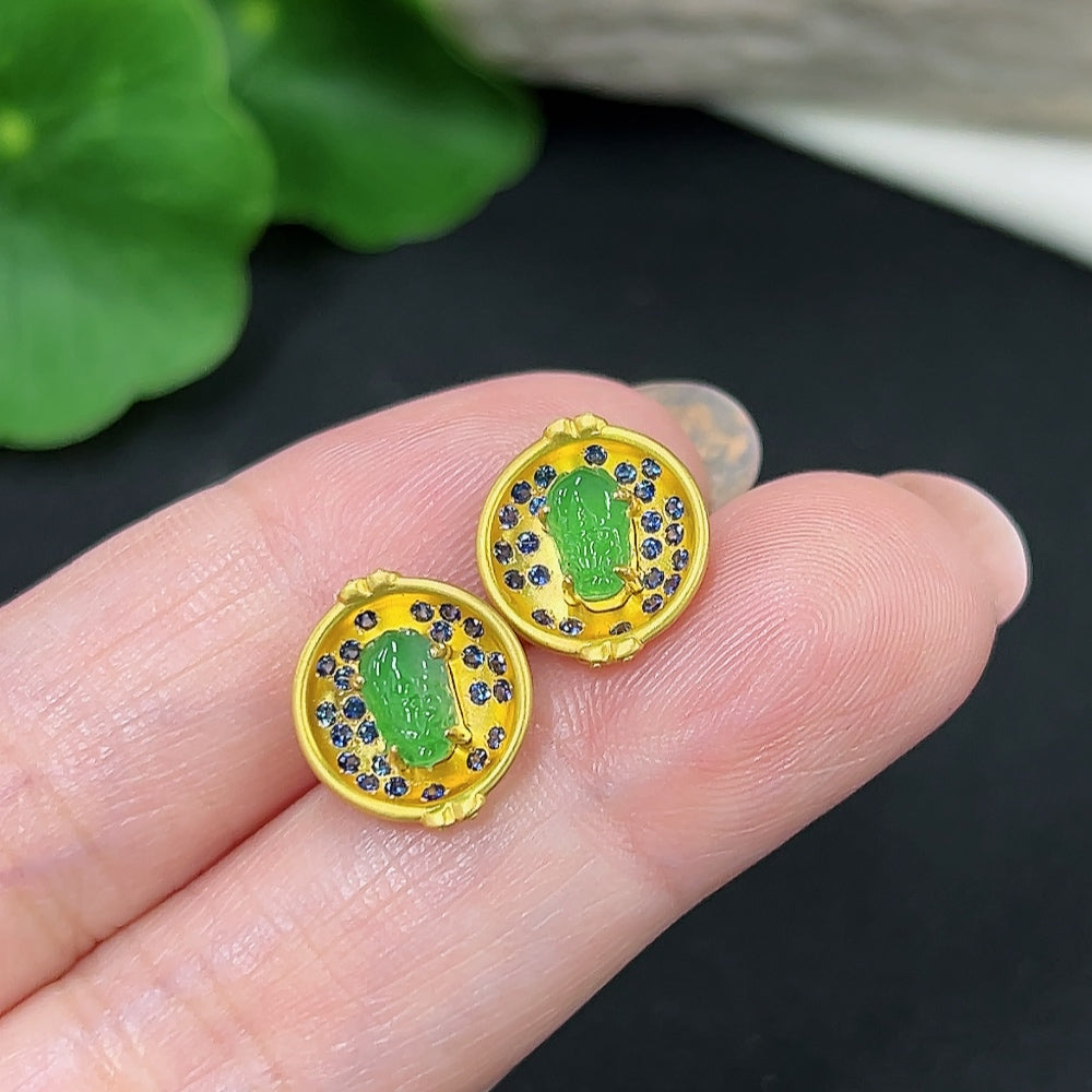 Pair of Jadeite earrings with 18K gold mounts, delicate design, showcasing vibrant green jade stones and gold accents.