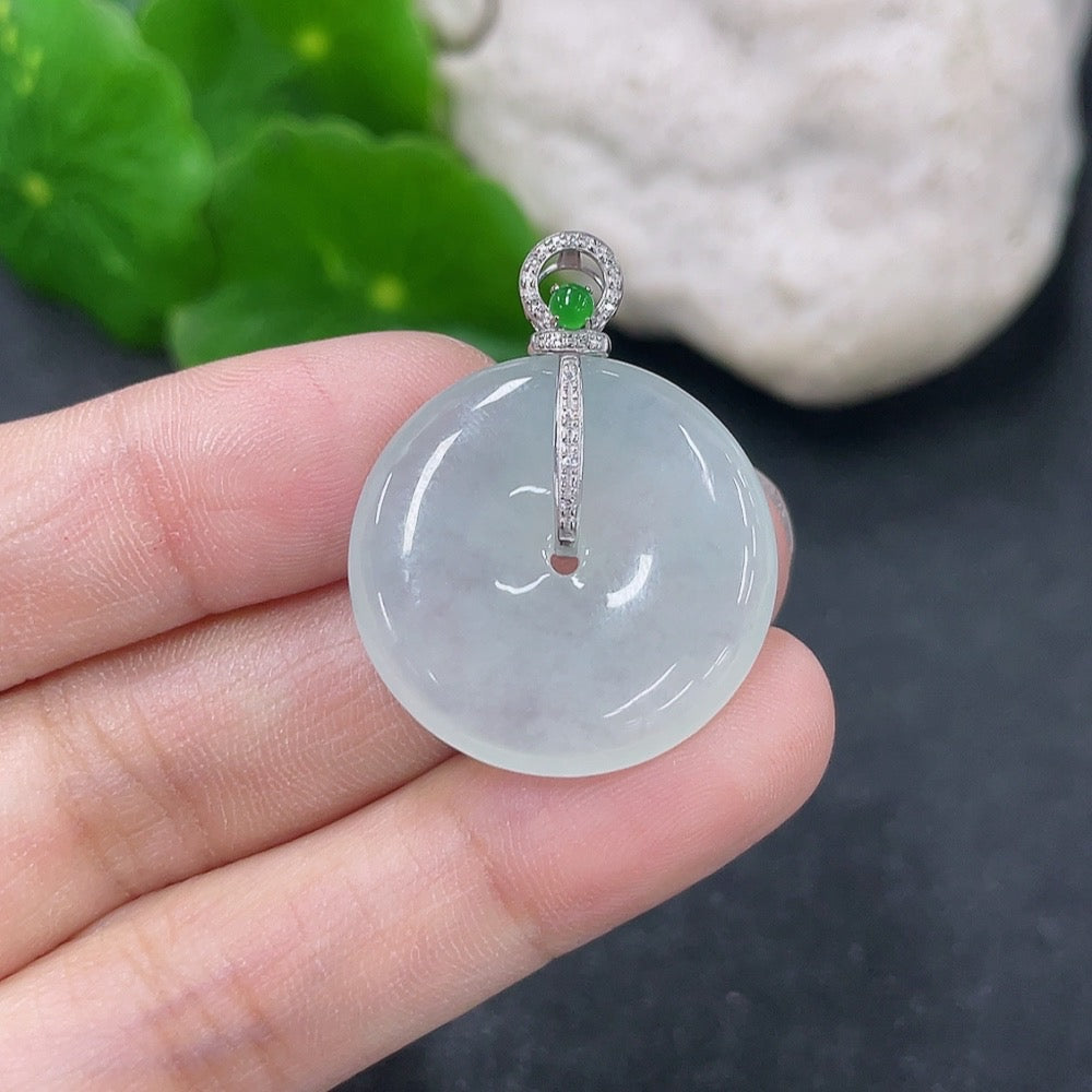 Jadeite pendant with peace knot design, 18k gold and diamond inlay, from HKHQ, weighing approximately 5.66 grams.