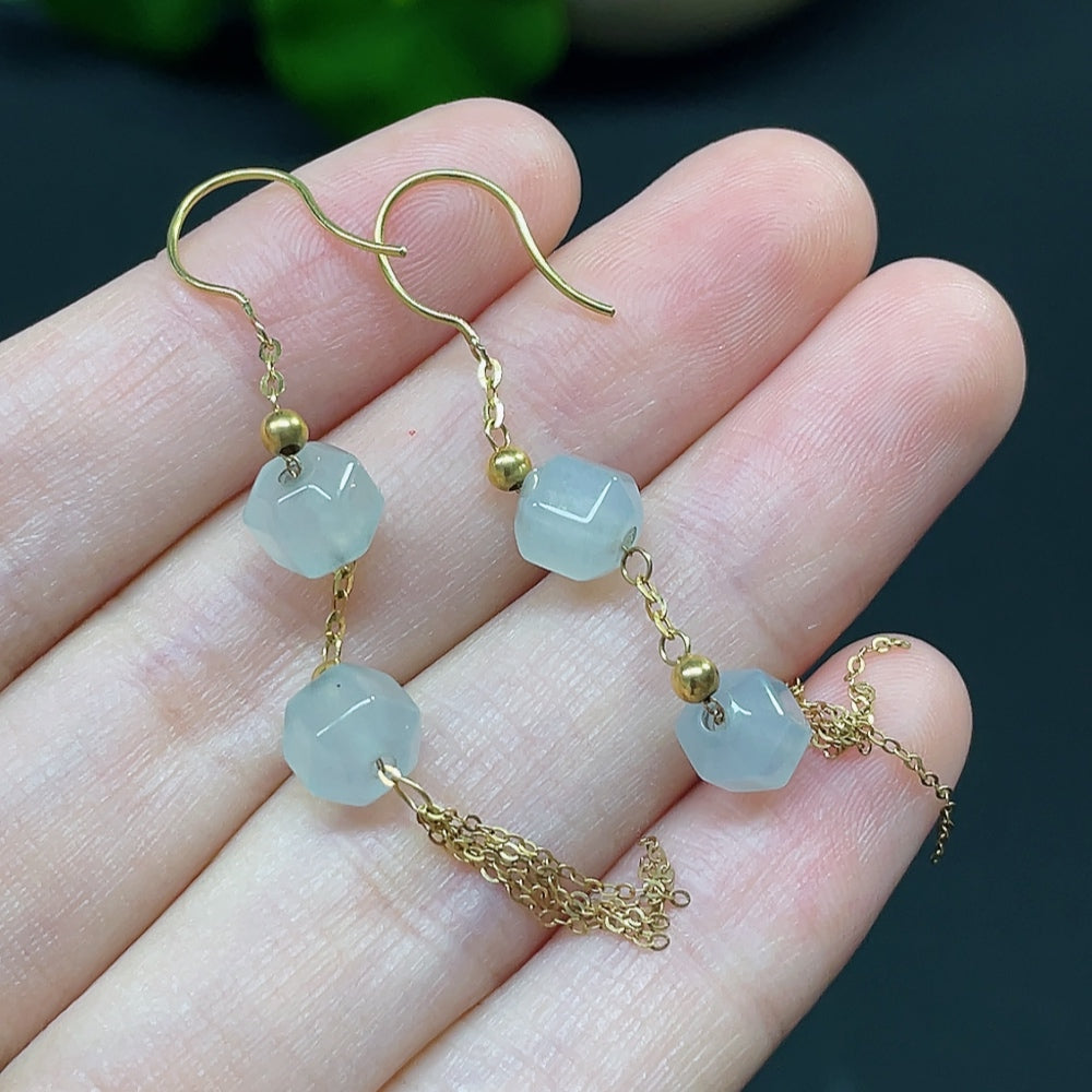 HKHQ jadeite bead inlaid earrings showcasing polished jade stones with gold accents, weighing approximately 3 grams.