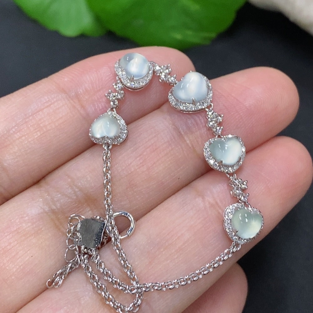 Jadeite inlaid bracelet by HKHQ with 18k gold and diamond accents, showcasing intricate craftsmanship and vibrant green jade.