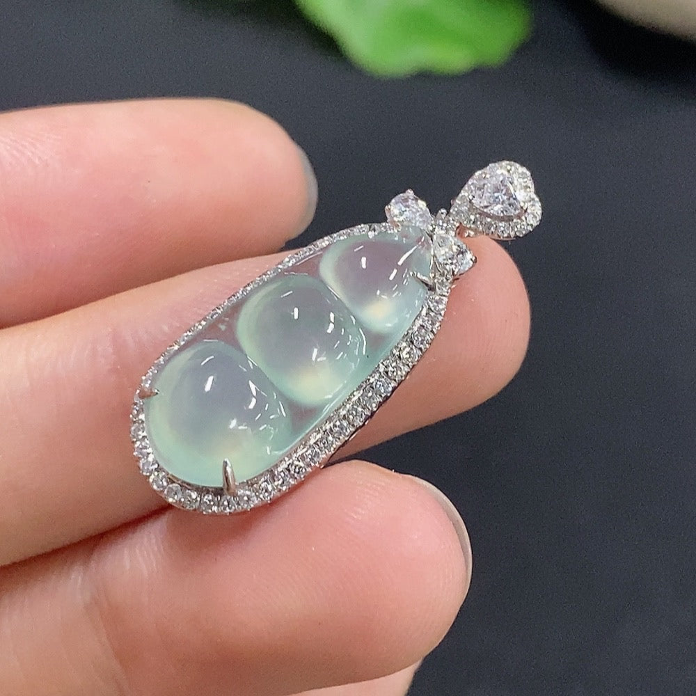 Jadeite lucky bean pendant with inlaid design, 18k gold, from HKHQ, showing detailed craftsmanship and vibrant green jade features.