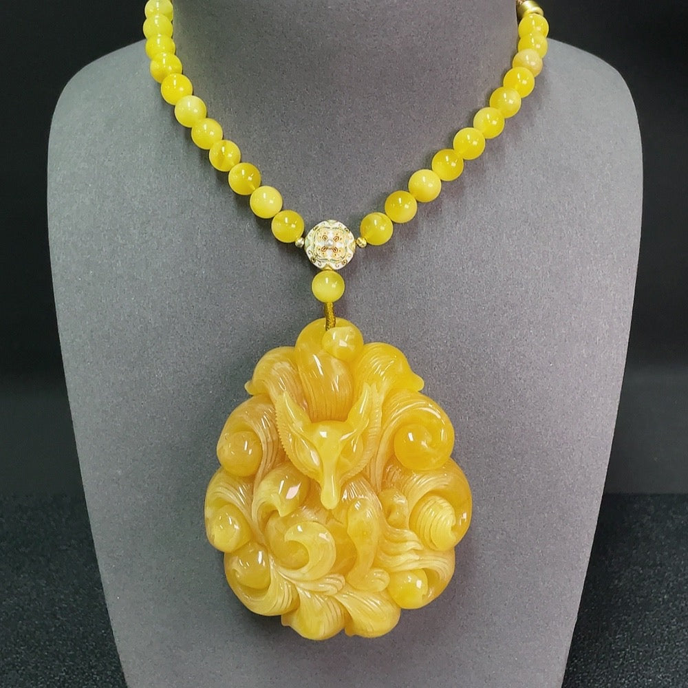 Amber beeswax gemstone pendant with cord, weighing approximately 95.63g, featuring natural-looking stones, from HKHQ.