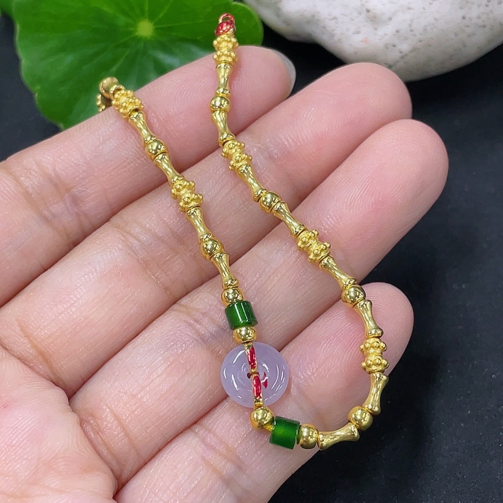 Jadeite inlaid bracelet with mixed gold components, featuring intricate gold accents and polished jadeite stones, by HKHQ.