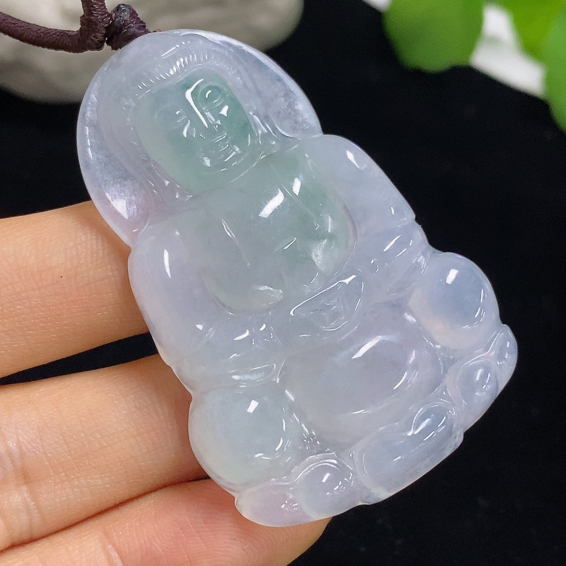 Jadeite Guanyin pendant with detailed carved figure, weighing approximately 21.6g, featuring a jade pendant with a rope chain.