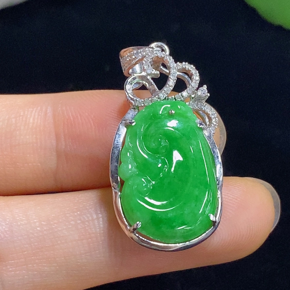HKHQ jadeite Ruyi pendant with gold inlay and diamond accents, showcasing intricate design and rich green color on a necklace.