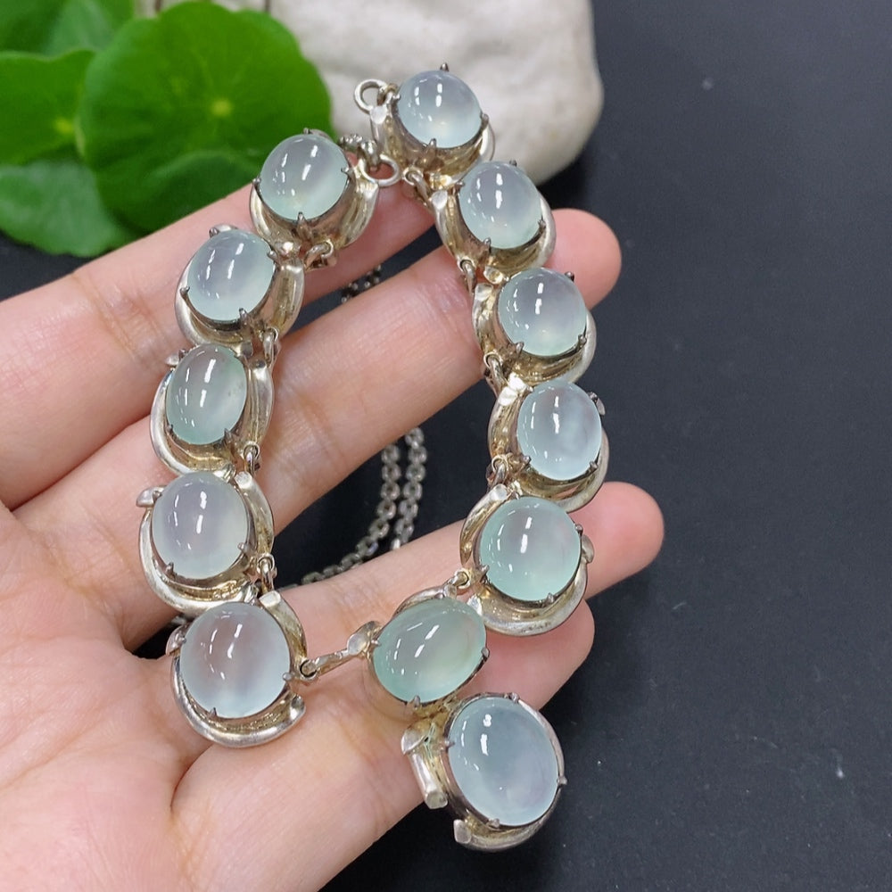 Jadeite cabochon in non-gold setting, weighing approximately 61.2g, showcasing smooth, polished green jade stone with natural luster.