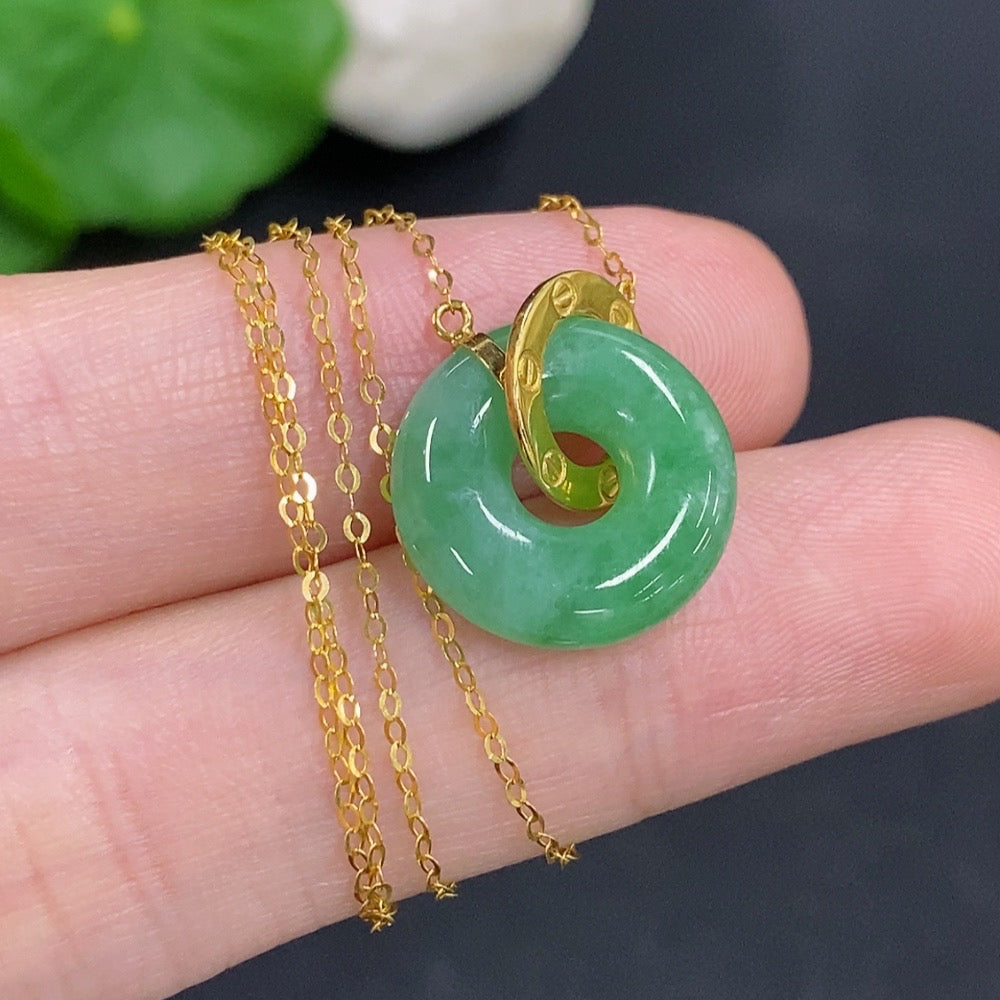 Jadeite donut pendant with 18k gold chain, HKHQ jewelry, showing the green jade and gold clasp on a white background.