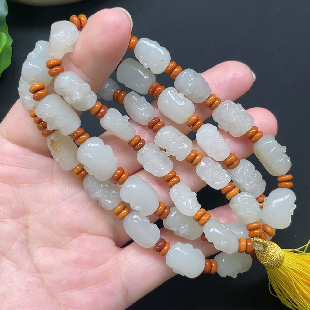 HKHQ Hetian Jade Eighteen Arhats bracelet with beaded string, approximately 65.71g, featuring colorful beads and detailed craftsmanship.