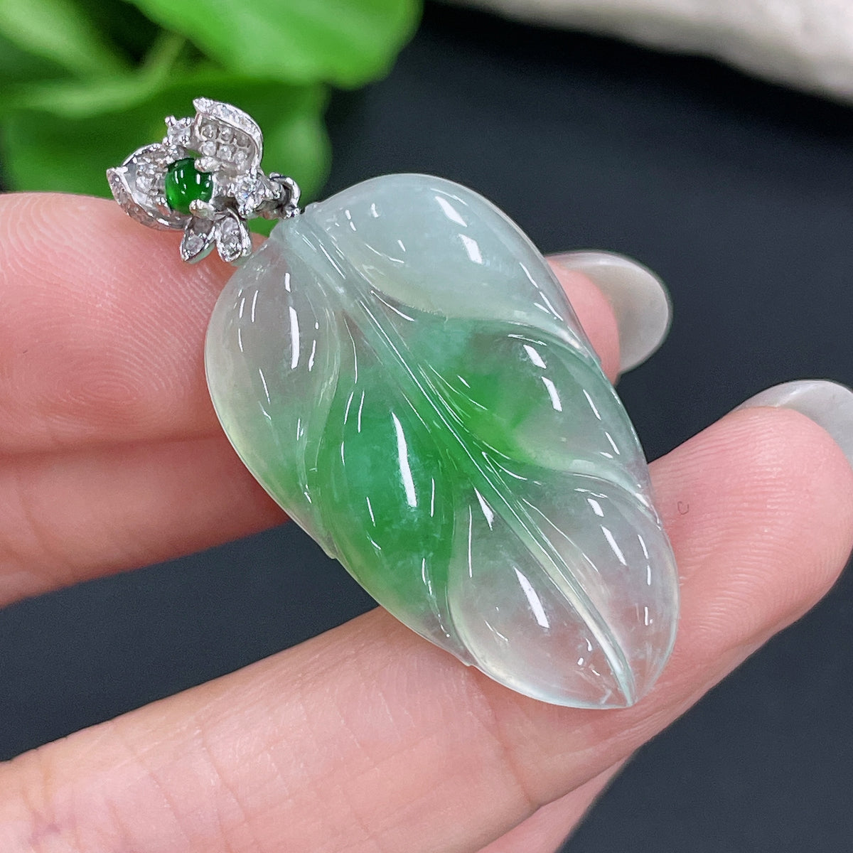 Jadeite pendant leaf with 18K bezel and diamond accents, crafted by HKHQ, showcasing intricate design and polished finish.