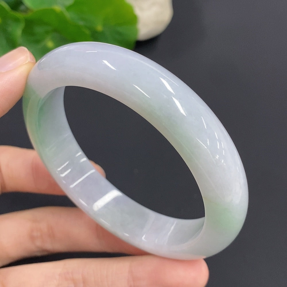 Jadeite round bangle with a 57mm size and 61.2g weight, crafted from green jade by HKHQ, showcasing smooth, polished surface.