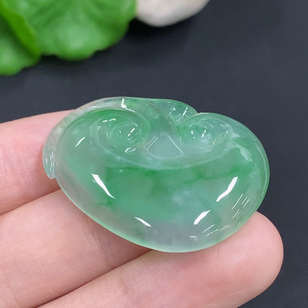 Jadeite Ruyi pendant with intricate carvings, weighing approximately 10.5 grams, showcasing smooth green jade from HKHQ.