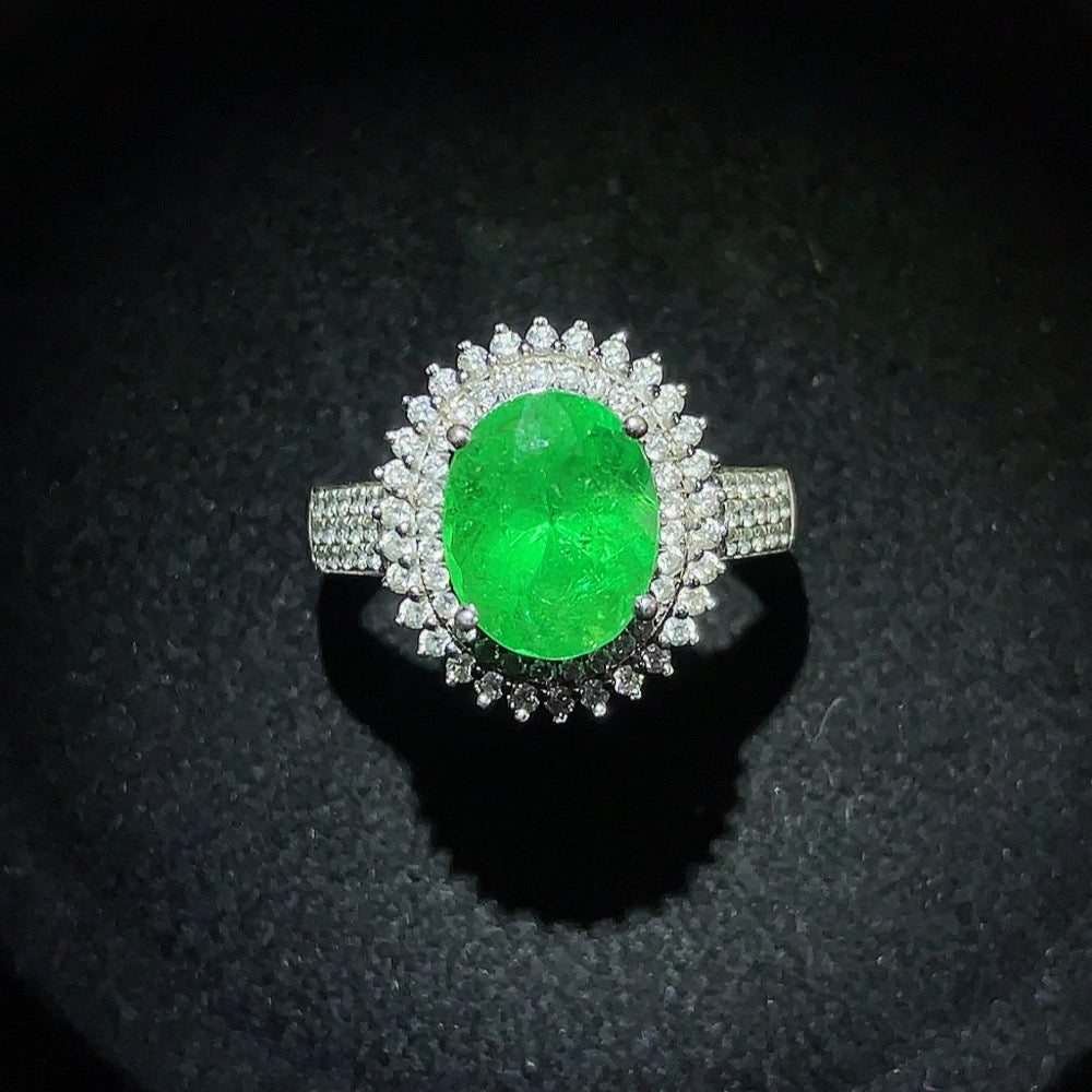 Emerald set ring by HKHQ in 18K gold, size 15 with gemstones, showcasing a vibrant green emerald centerpiece and gold band.